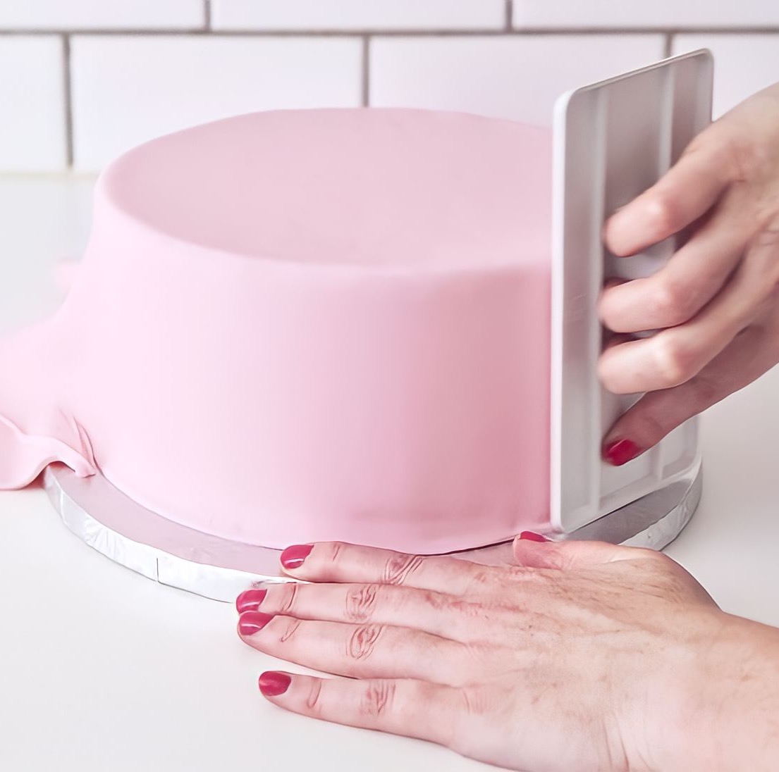 Smoothing the fondant on the cake